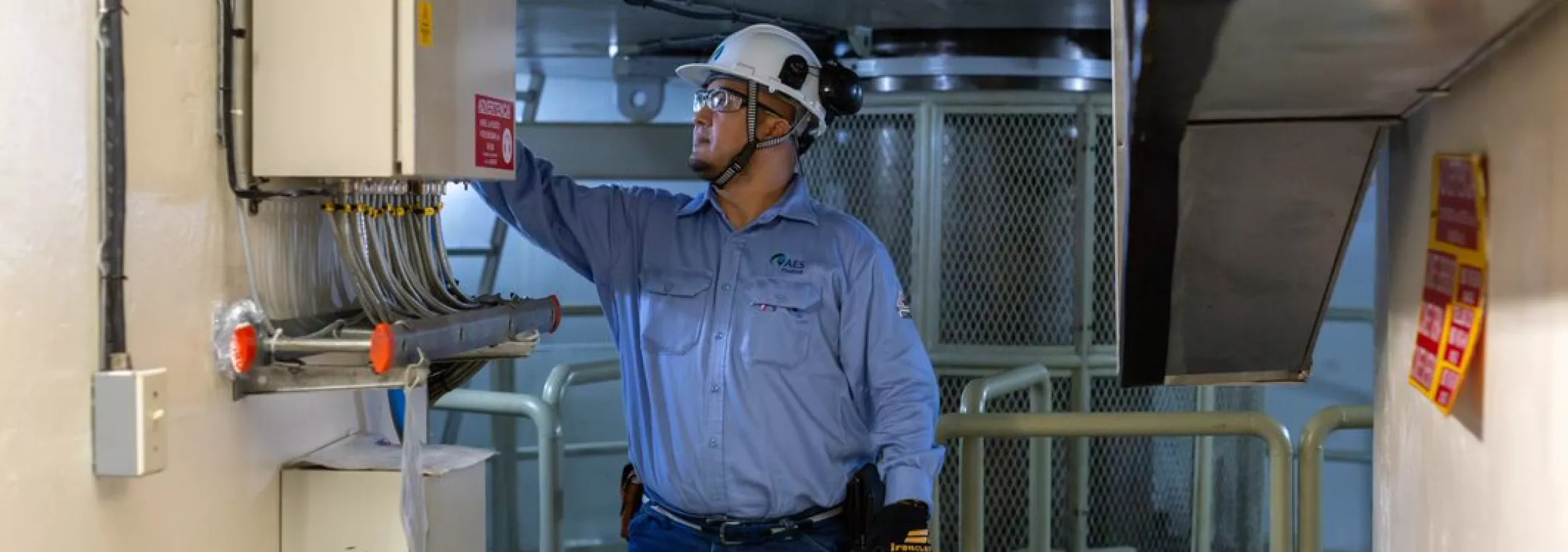 people - man in hard hat works on control box panama